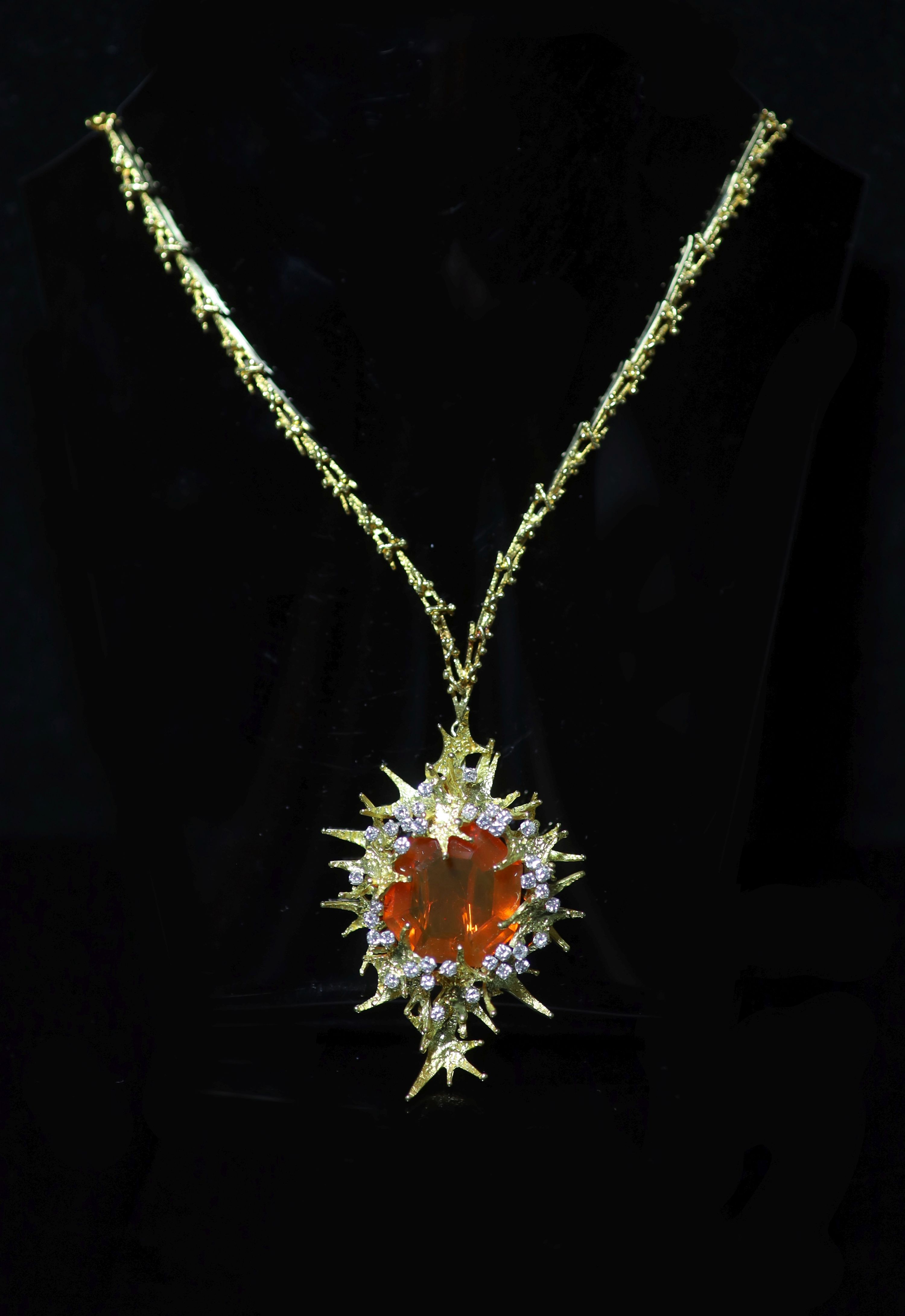 A stylish 1970's George Weil 18ct gold, platinum, fire opal and diamond set shaped oval pendant clip brooch, on an 18ct gold chain
